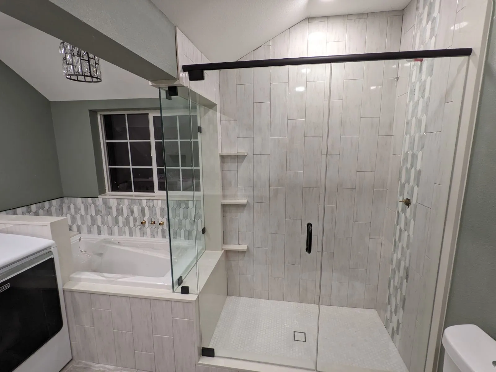 Tiled shower beside a soaking tub